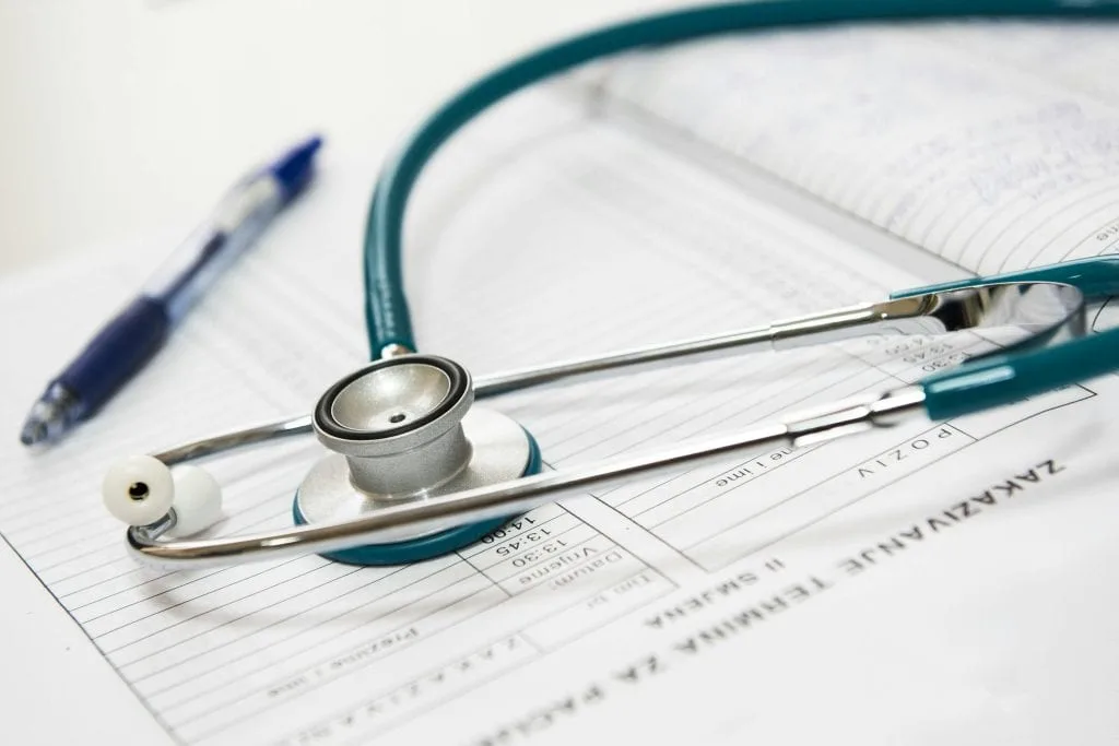 medical-appointment-doctor-healthcare-40568-40568-1 A stethoscope and pen resting on a medical report in a healthcare setting.